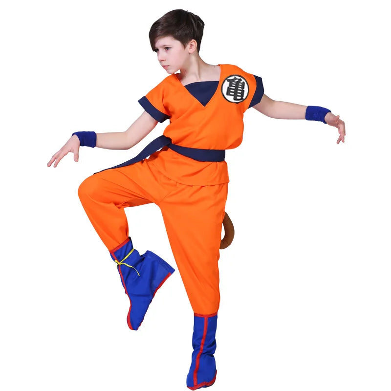 Boy wearing the Goku kids costume mid-pose with the tail, wristbands and blue boot covers