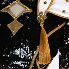 Close-up of the gold tassel, velvet trim and black sequins on the Zoey costume