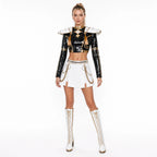 Adult model wearing the Zoey costume: black sequin top with gold collar detail, studded epaulettes, white pleated skirt and layered gold chains